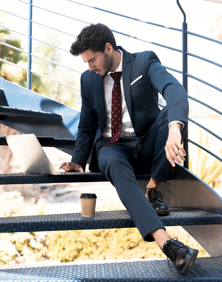Model im Anzug mit klassischen, dezent erhöhenden Business-Schuhen.