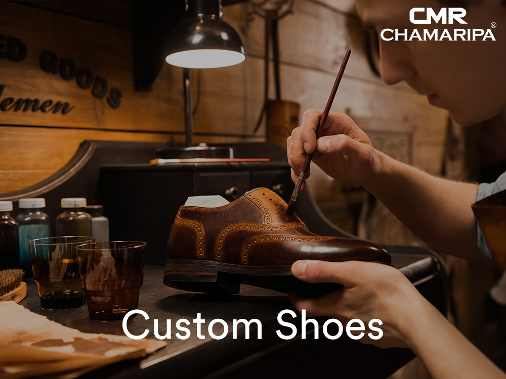Craftsman hand-painting and finishing a leather custom elevator shoe for men in Canada.