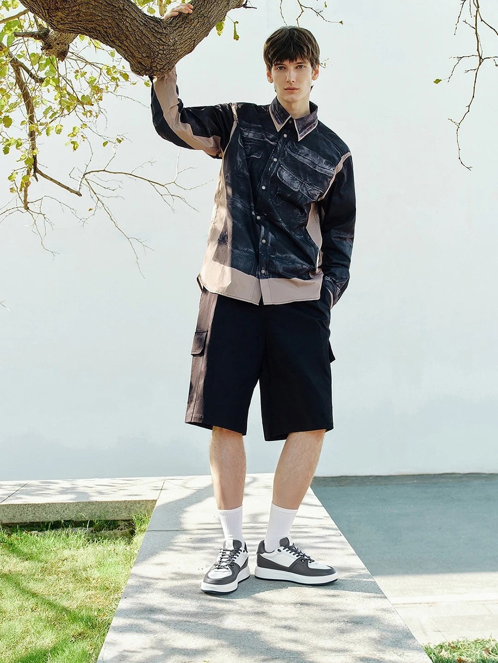 Model wearing wide-fit grey leather elevator sneakers for casual gatherings and all-day comfort