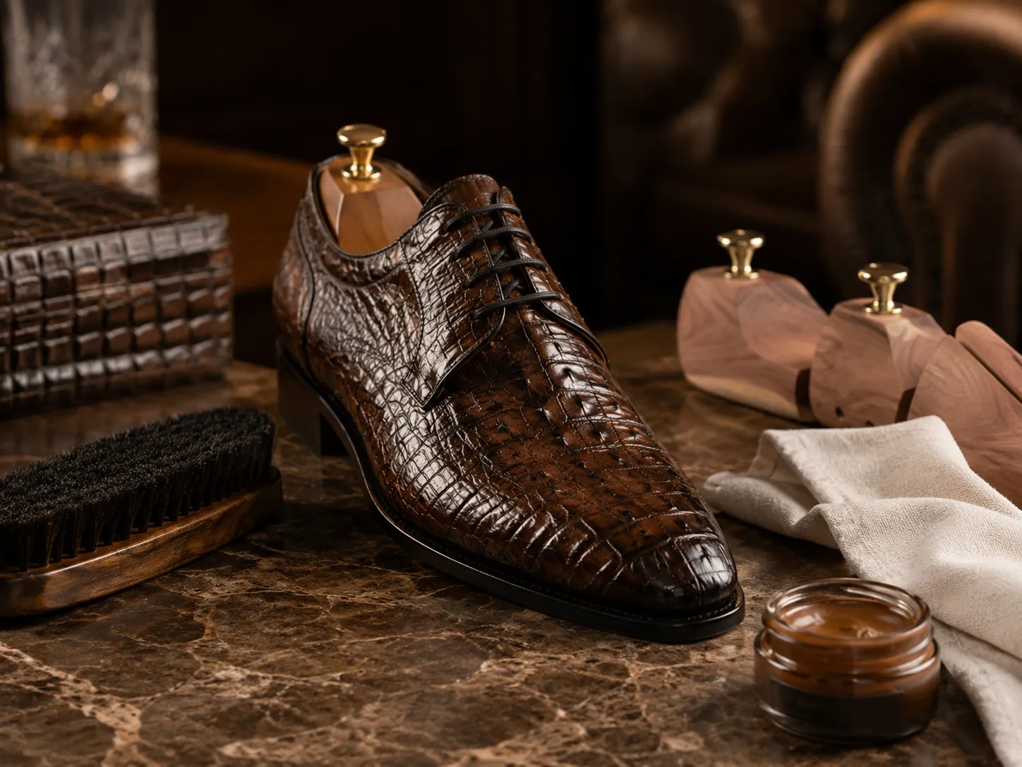 Essential leather care kit for luxury dress shoes featuring a professional horsehair brush and leather balm.